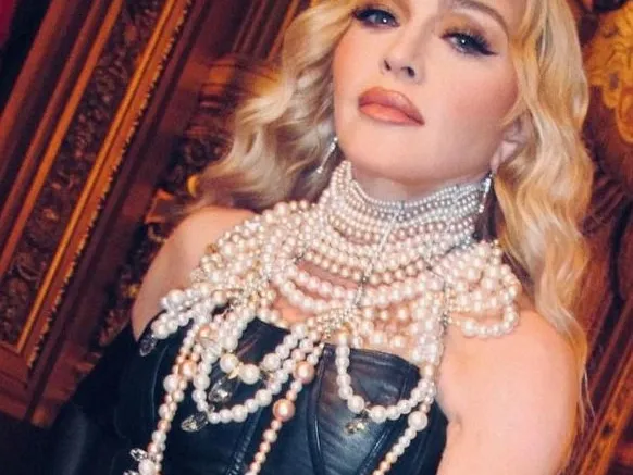 Madonna pairs black corset with pearl necklaces, fishnets in new pictures